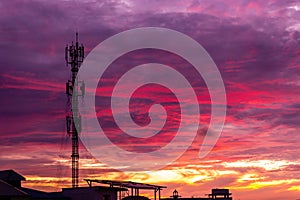 Silhouette signal antenna tower at sunset sky