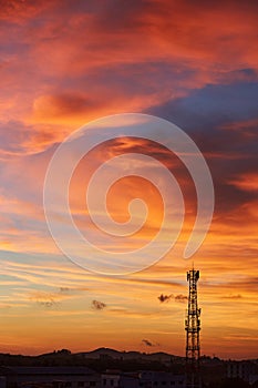 Silhouette signal antenna tower at sunset sky