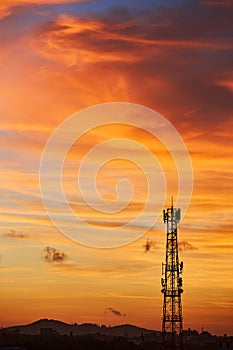 Silhouette signal antenna tower at sunset sky