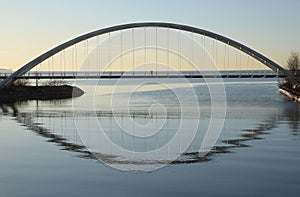 Silhouette of a single mounted cyclist on Humber Bay Arch Bridge