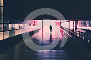 Silhouette of a single person walking in tunnel