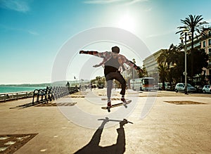 Silhouette of skateboarder in city