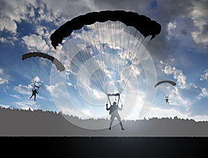 Silhouette skydiver parachutist landing