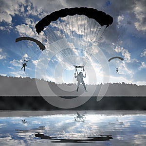 Silhouette skydiver parachutist landing