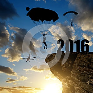 Silhouette skydiver parachutist landing in to the New Year 2016