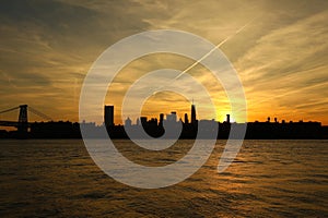 silhouette of skyscrapers and Williamsburg Bridge in New York at sunset