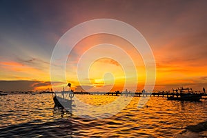 Silhouette Small fishing boat at shore in sunset at Bang Phra Beach,sriracha choburi,thailand