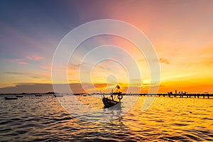 Silhouette Small fishing boat at shore in sunset at Bang Phra Beach,sriracha choburi,thailand