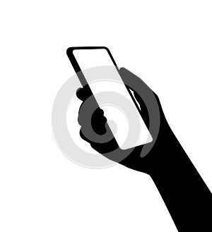 A silhouette of a smartphone in person hand. Using new computer technologies and applications for mobil phones