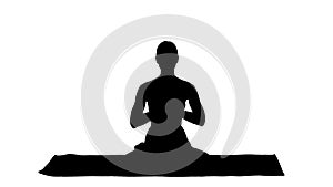 Silhouette Smiling woman yoga meditating sitting lotus, hands co