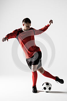 Silhouette of soccer player man playing kicking isolated on white background photo