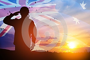 Silhouette of soldier on background of Australia flag and the sunset or the sunrise background. Anzac Day.