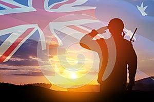 Silhouette of soldier on background of Australia flag and the sunset or the sunrise background. Anzac Day.