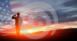 Silhouette of soldier saluting on background of USA flag. Greeting card for Veterans Day, Memorial Day.