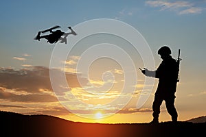 Silhouette of soldier are using drone and laptop computer for scouting during military operation.