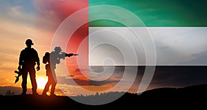 Silhouette of soldiers against the flag of UAE. Concept of national holidays.