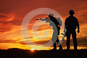 Silhouette of a soldiers against the sunrise. Concept - protection, patriotism, honor.