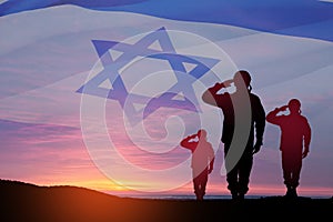 Silhouette of soldiers saluting against the sunrise in the desert and Israel flag.