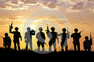 Silhouette of Soldiers team with sunrise background