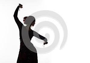 Silhouette of spanish girl flamenco dancer on a light background. free space for your text