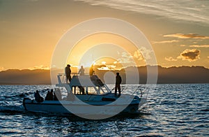 Silhouette of Speed boat in the ocean at sunset
