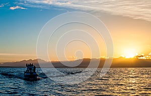 Silhouette of Speed boat in the ocean at sunset