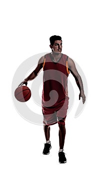 Silhouette of sportsman playing basketball on white background