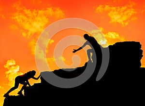 Silhouette Sporty woman climbing on the cliff.