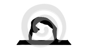 Silhouette Sporty yoga girl performing Chakrasana Urdva Dhanuras