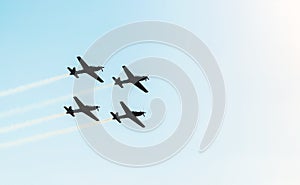 Silhouette of a squad of four airplanes flying together
