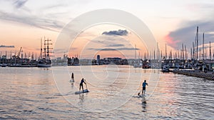 Silhouette of stand up paddle boarder paddling