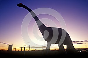 Silhouette of statue of Brontosaurus, SD at sunset