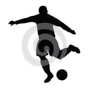 Silhouette of a striker who kicking a ball. photo