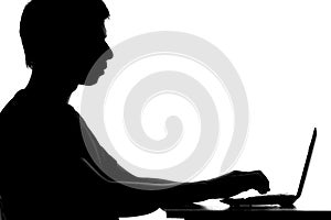 Silhouette of a student learning remotely with the Internet u