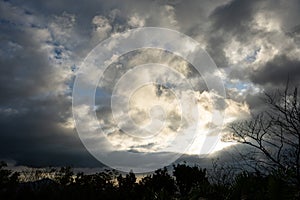 Silhouette of the sun on a dark rainy sky