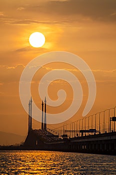 Silhouette sun at mid span cable stayed bridge