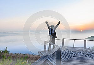 Silhouette the sunrise with a wooden skywalk, the fog, the beautiful sky and cloud at Phu Lam Duan Mountain, Pak Chom District,