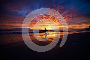 Silhouette of surfer in the background of vibrant sunset scenery, Nosara peninsula, Costa Rica