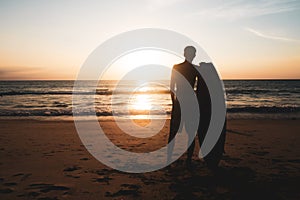 Silhouette of surfer man carrying their surfboards on sunset beach with sun light