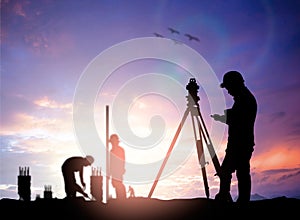 Silhouette survey engineer working in a building site over Blur