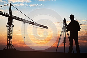 Surveyor Standing With Equipment At Construction Site photo