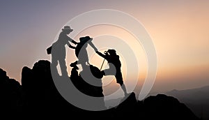 Silhouette of teamwork of three mountain climbers helping each other on the mountain top, climbing team, Hiking, friendship as a