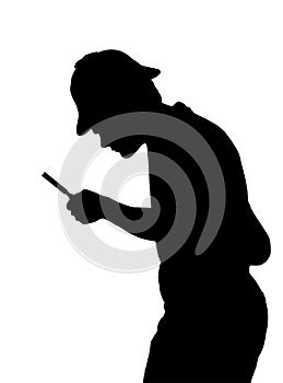 Silhouette of teenage boy investigating with a magnifying glass photo