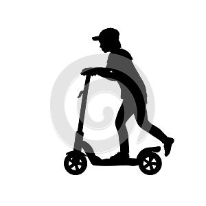 Silhouette teenage boy riding scooter