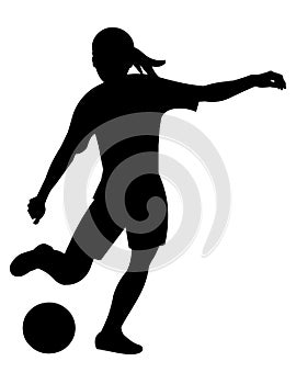 Silhouette of a teenage girl playing women's football and going to kick the ball with her foot