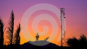 Silhouette of telecommunication antenna cellular tower for telephony with beautiful sunset