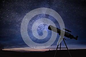 Silhouette of telescope and starry night sky in background. Astronomy and stars observing.