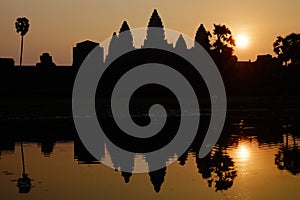 Silhouette of the temple Angkor wat and its reflection in the lake at sunrise