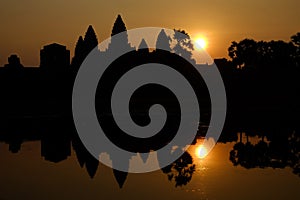 Silhouette of the temple Angkor wat and its reflection in the lake at sunrise