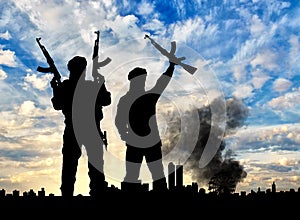 Silhouette of the terrorists and the city photo